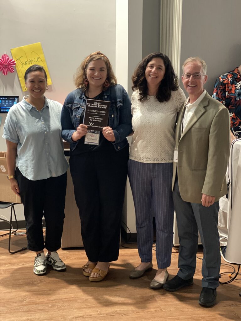 Kelli Nelson receiving the 2023 George Mader award on behalf of From Mission to Mission